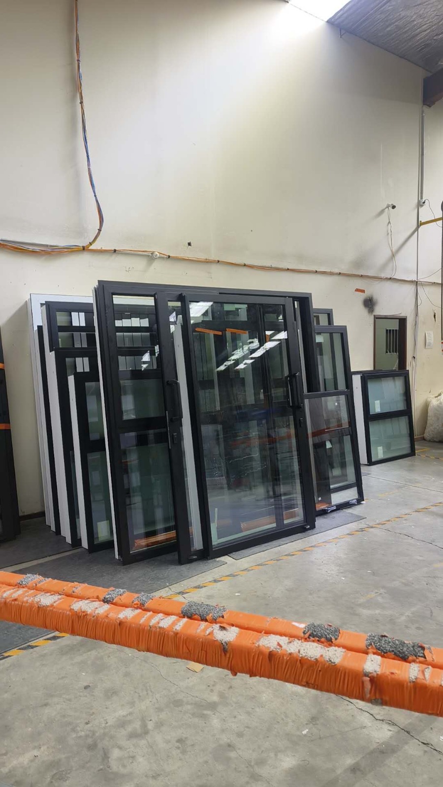 Black aluminium sliding door units prepared for supply