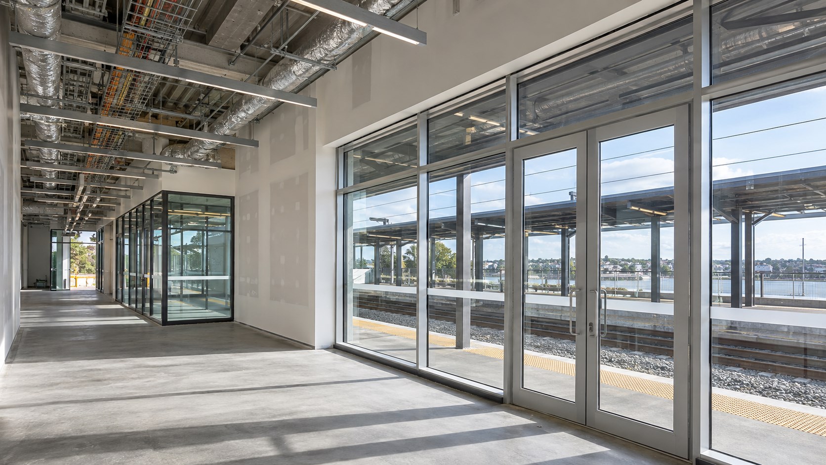 Modern transport station fit-out with aluminium-framed glazing
